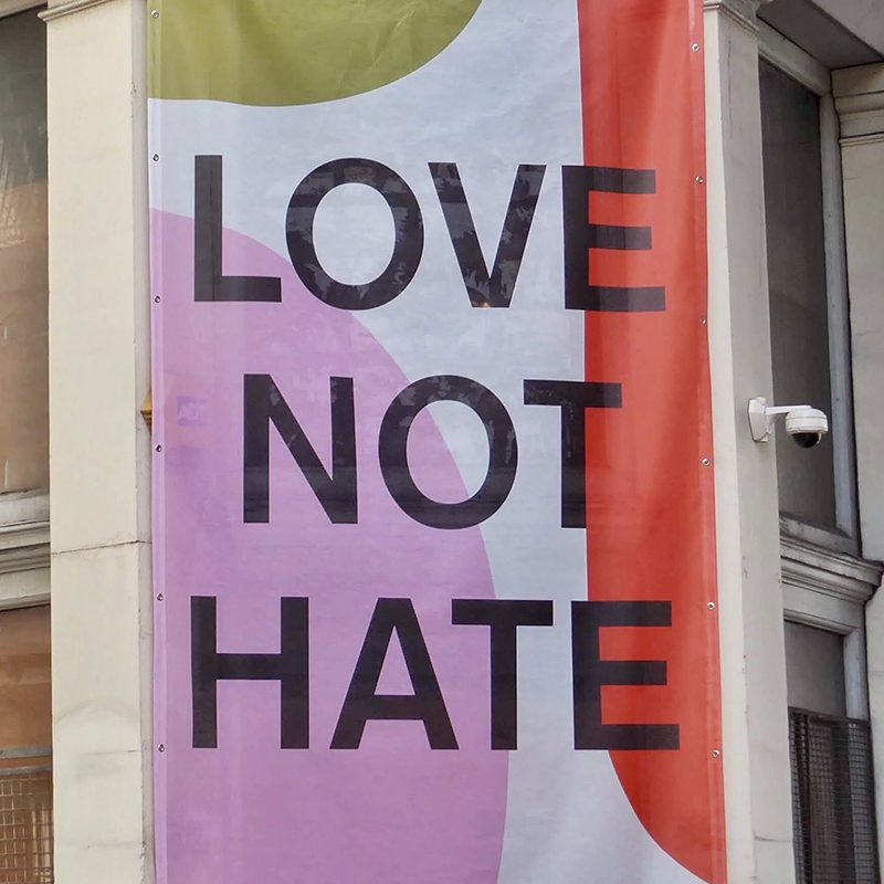Love not hate banner on building