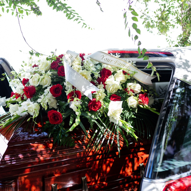 A funeral acknowledgment card on top of a casket