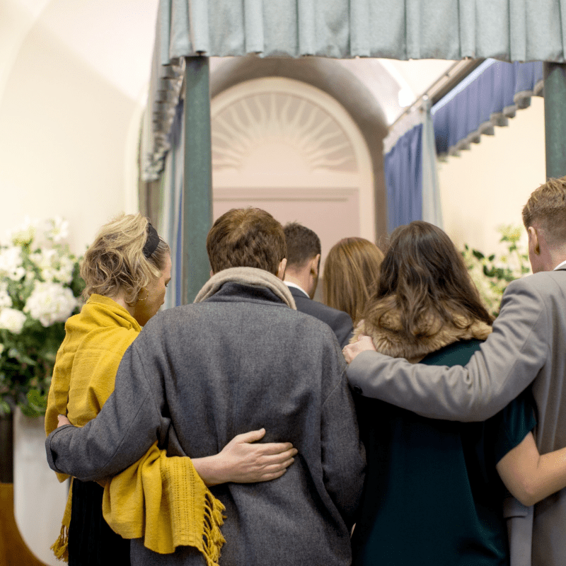 Mourners consoling one another