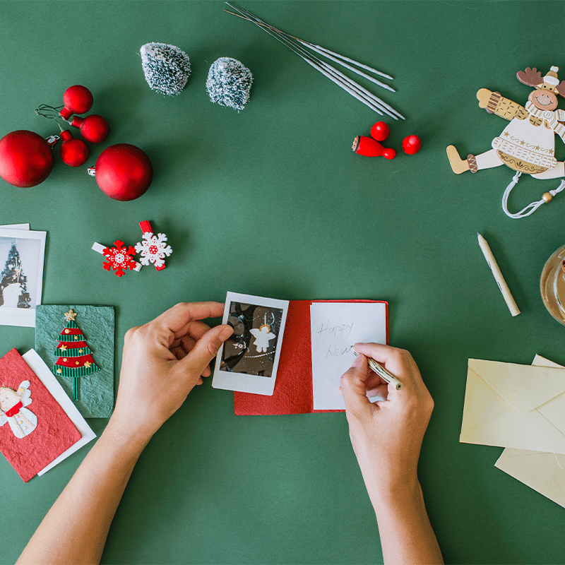 Woman's hands writing Christmas card