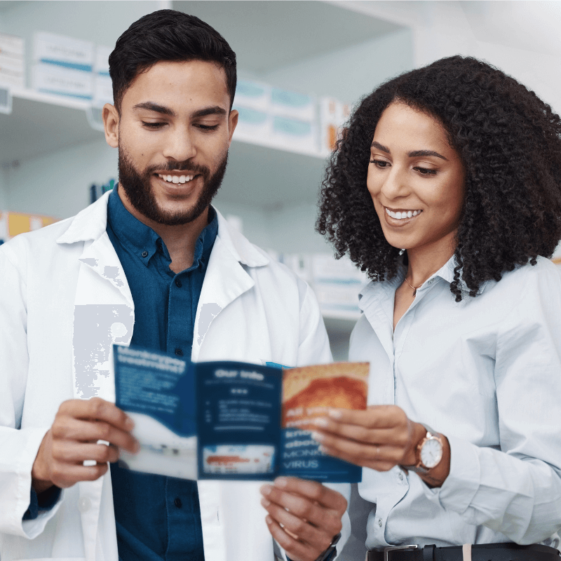 pharmacy-medicine-and-brochure-with-people Physicians looking at health care brochure