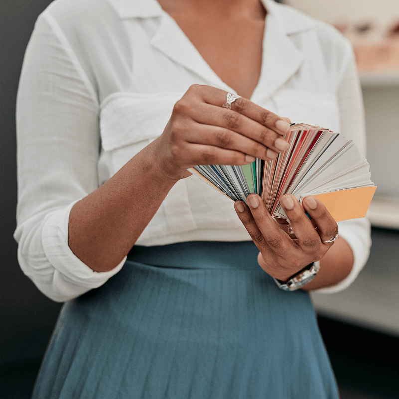 its-all-about-the-color woman looking through paper choices for business cards