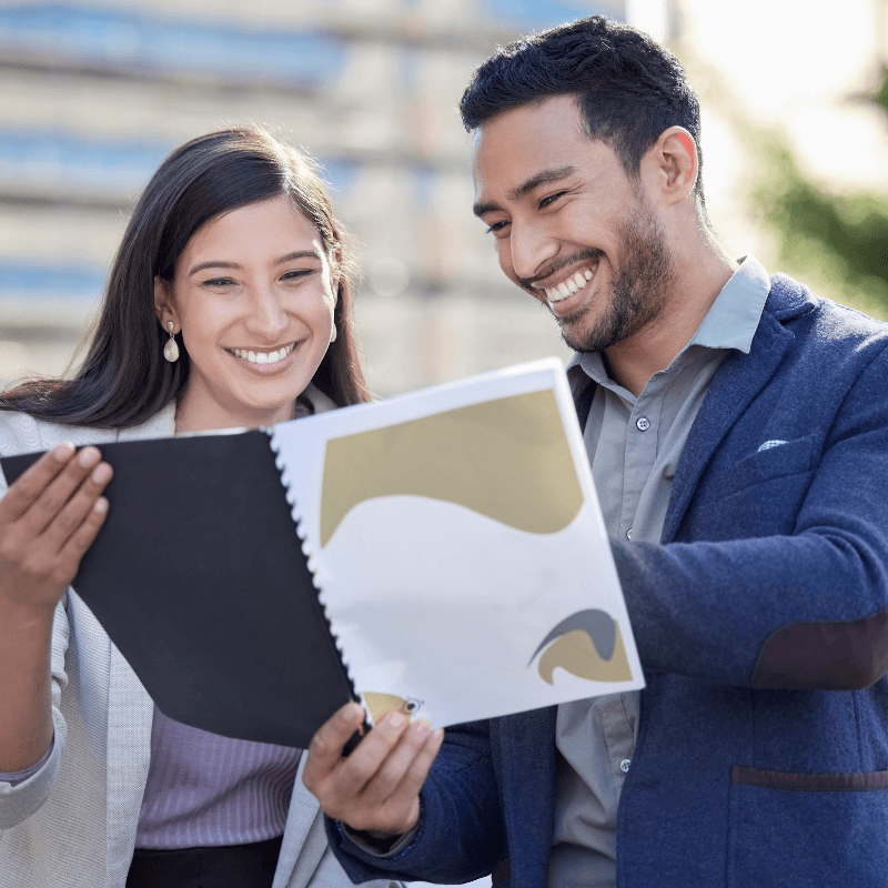 our-numbers-have-really-improved business people looking over business materials