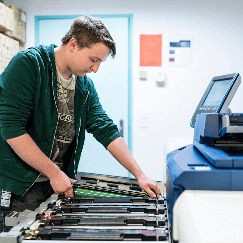 teenager working with a color printer teenager working with a color printer