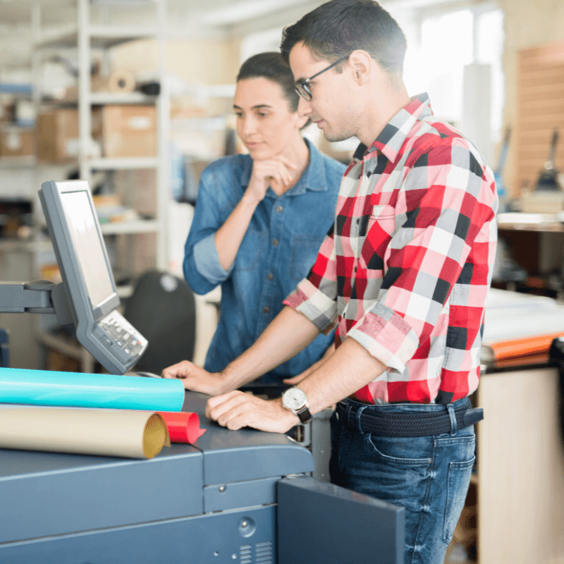 coworking-man-and-woman-using-printer-2025 printers in their print shop