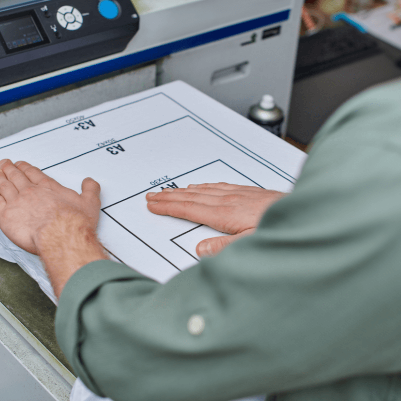 cropped-view-of-young-artisan-working-with-t-shirt cropped view of a young print artisan working with a t-shirt