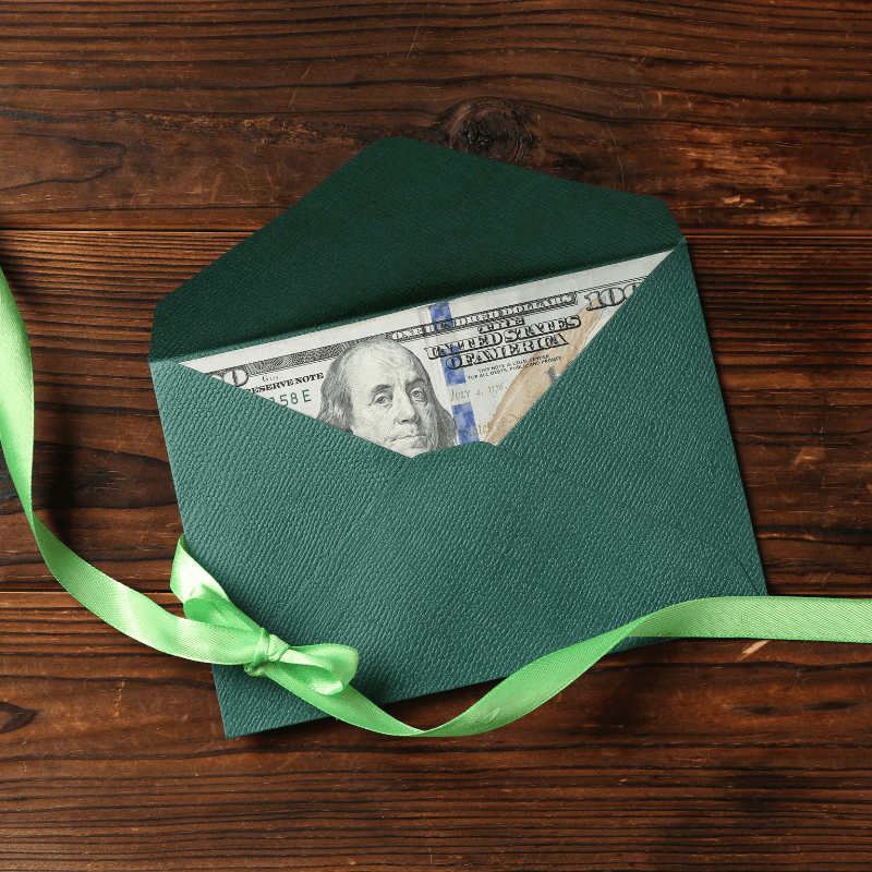 Green envelope with money peeking out the top