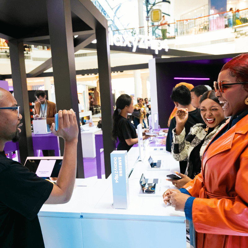 customers shopping at a mobile phone booth at trade show