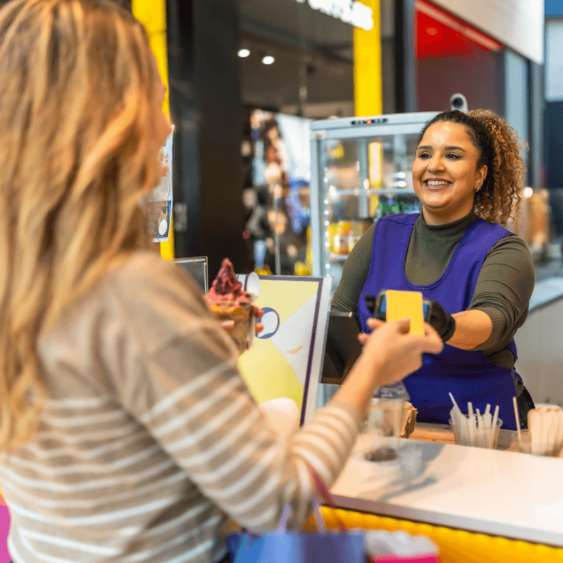 woman paying the cashier at a trade show booth