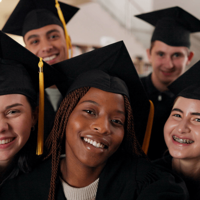 group of high school graduates smiling at camera