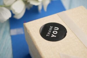 Close up of black and white Thank You sticker on a package.
