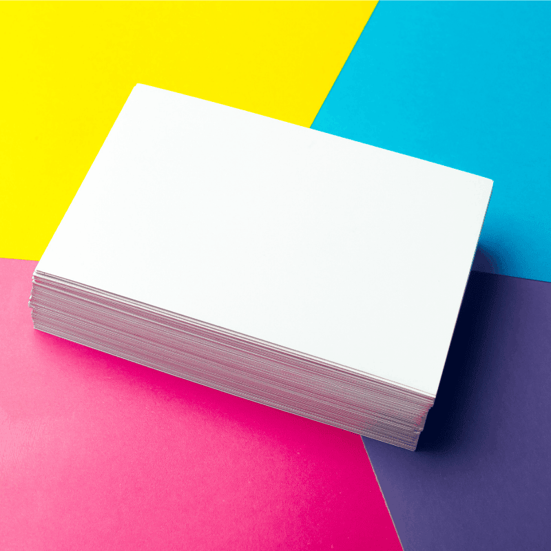 colorful-abstract-background-with-stacked-white-paaper Stack of multi-colored craft paper